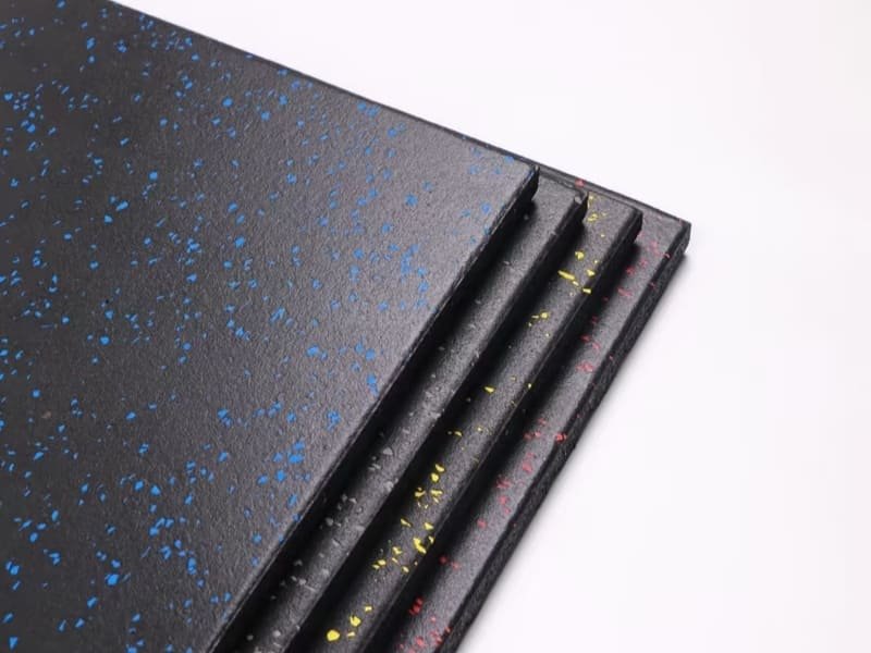 A detailed image of a waterjet-cut custom logo being inlaid into a rubber gym floor